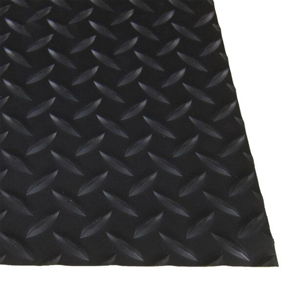 A close-up of a black rubber diamond plate with a black rubber band.