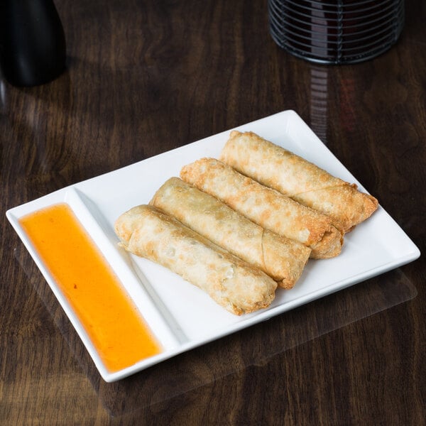 Fried spring rolls on a Libbey Ultra Bright White porcelain cocktail plate with 2 compartments.
