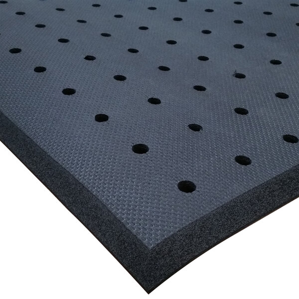 A black Cactus Mat rubber floor mat with drainage holes.
