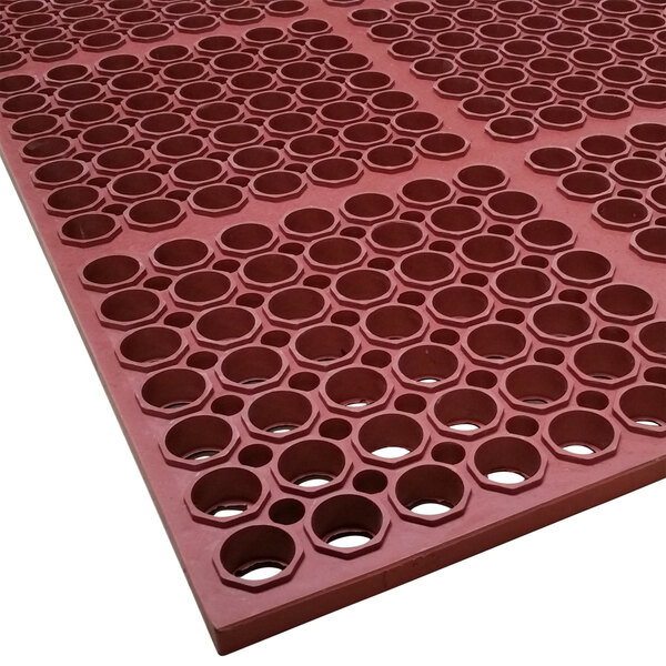 A red Cactus Mat with holes in it.