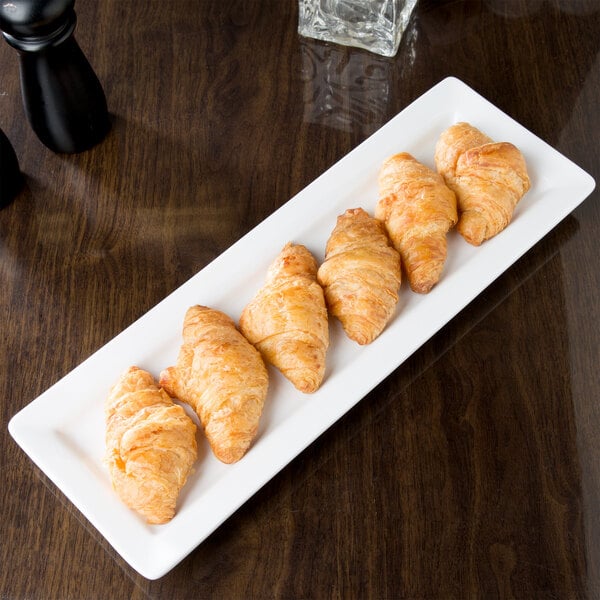 A plate of croissants on a Libbey ultra bright white rectangular porcelain plate.