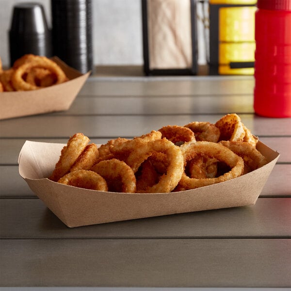 A #500 Natural Eco-Kraft paper food tray filled with fried onion rings on a table.
