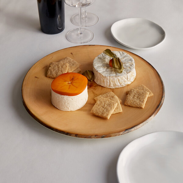 An American Metalcraft round melamine charger with cheese and crackers on it.