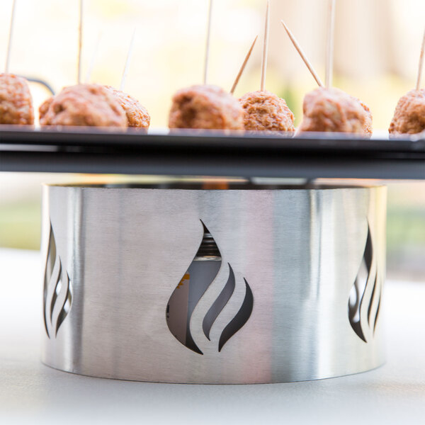 American Metalcraft small chafer wind guard on a tray of meatballs on a table in an outdoor catering setup.