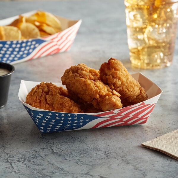A tray of fried chicken and chips in a USA flag paper food tray.