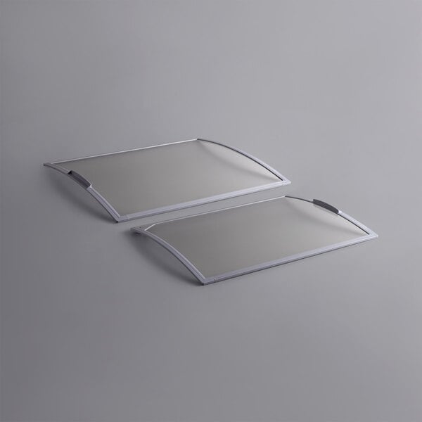 A pair of white rectangular plastic lids with a white border.