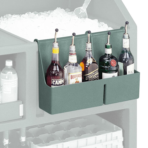 A Cambro slate blue speed rail holding bottles of liquor on a counter.