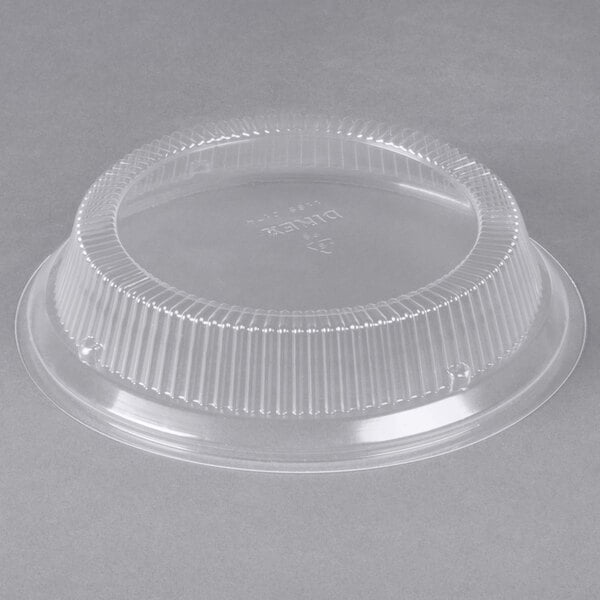 A clear plastic container with a round plastic lid.