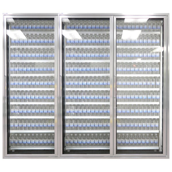 A Styleline walk-in cooler with shelves of water bottles with blue labels.