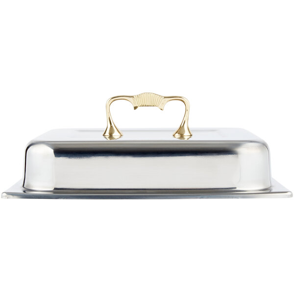 A silver chafer cover with a gold handle.