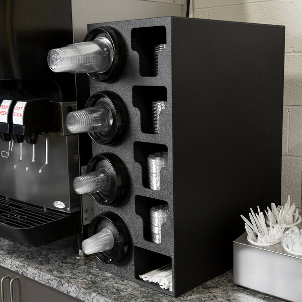 A black countertop cabinet with plastic cups and straws in it.