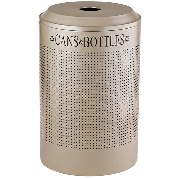 A silver round Rubbermaid recycling receptacle with holes for cans and bottles.