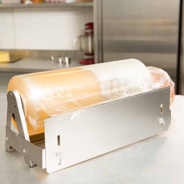 A roll of Berry Standard Miler plastic wrap on a metal stand.