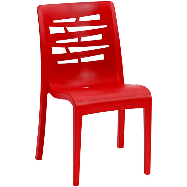 A pack of 4 red Grosfillex resin outdoor restaurant chairs with holes in the back.