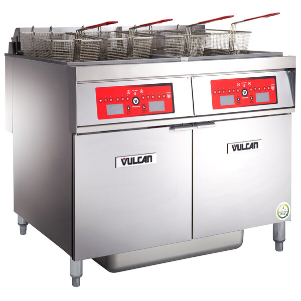 A Vulcan electric floor fryer system with two units on a counter in a school kitchen.