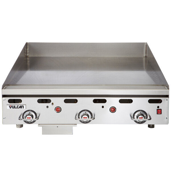 A close-up of a Vulcan liquid propane gas griddle with snap-action thermostatic controls.