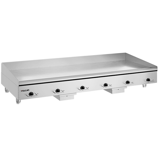 A large stainless steel Vulcan countertop griddle with knobs.