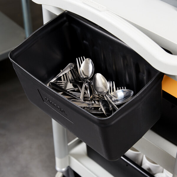 A black container with silverware in it.