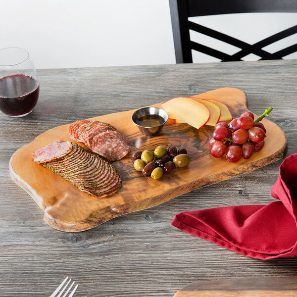 An American Metalcraft faux olive wood melamine serving board with food on it on a table