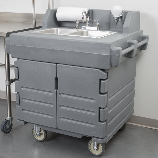 A gray Cambro CamKiosk portable self-contained hand sink on a cart.
