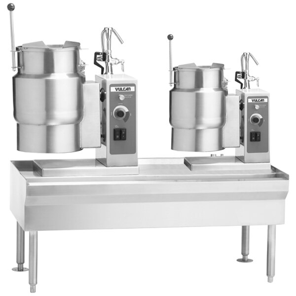 A Vulcan table with two electric tilting kettles holding large pots.