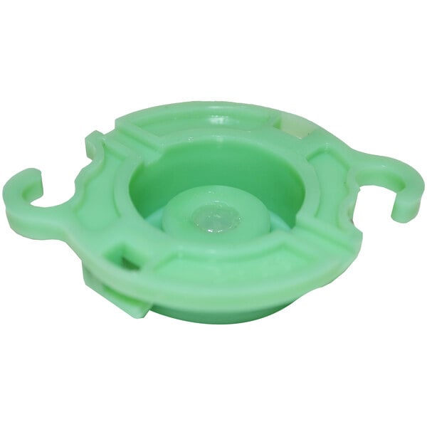 A green plastic Curtis whipper plate with a hole in the center.