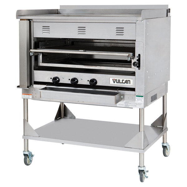 A stainless steel Vulcan Chophouse ceramic broiler with wheels.