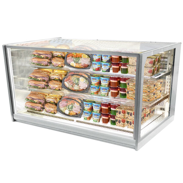 A Federal Industries Italian Series drop-in refrigerated bakery display case with food on shelves.