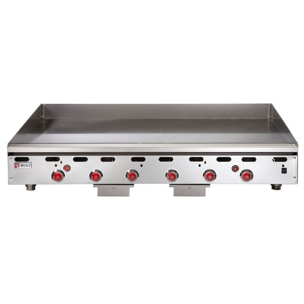 A Wolf natural gas countertop griddle with snap-action thermostatic controls and red knobs.