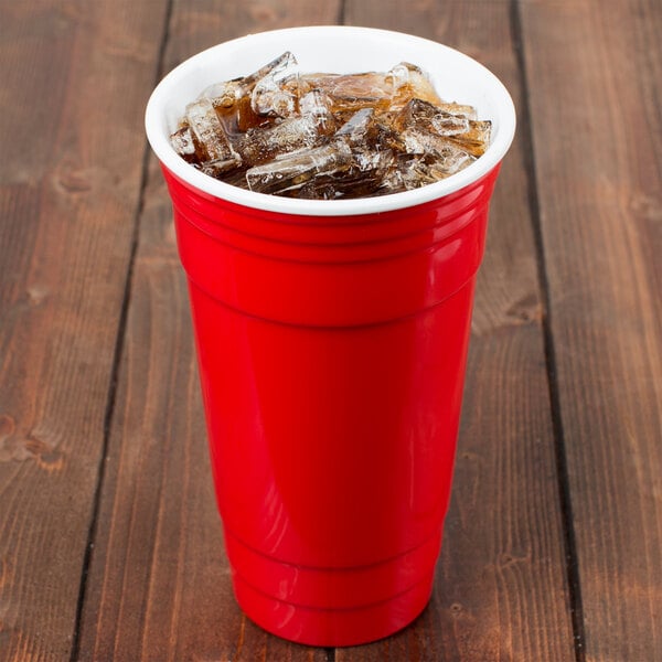 A red GET SC-32-R plastic tumbler filled with ice on a wooden table.