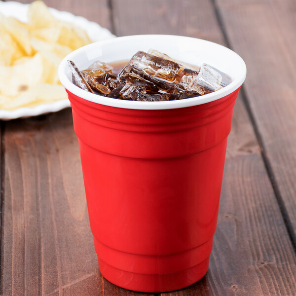 A red GET To-Go tumbler with ice in it.