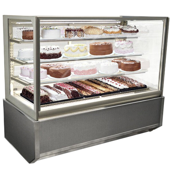 A Federal Industries refrigerated bakery display case with cakes and pastries on it.