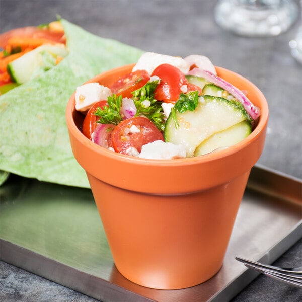 An American Metalcraft terra cotta melamine pot with a salad and tortilla wrap.