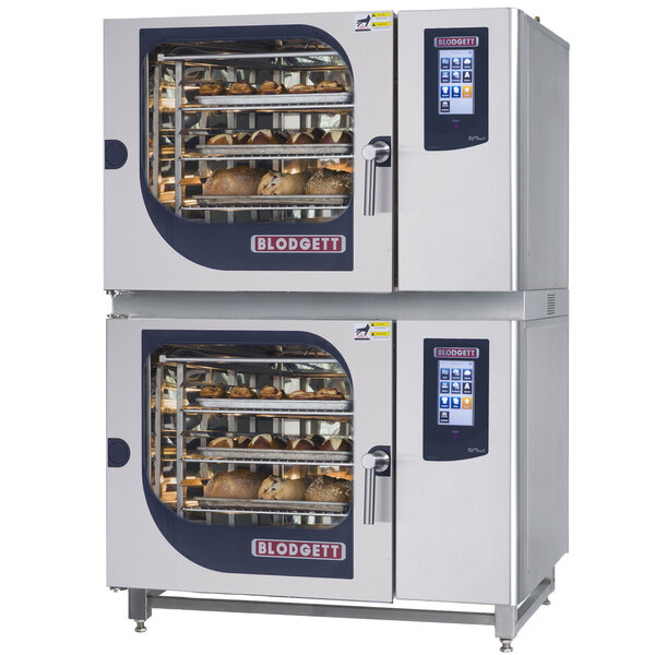A Blodgett double boilerless electric combi oven with touchscreen controls on two large ovens with food in them.