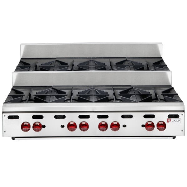 A Wolf countertop range with eight burners on a counter.