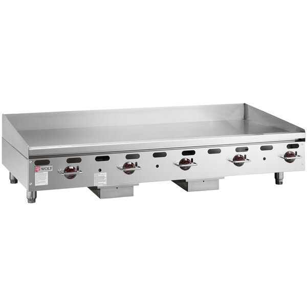 A Wolf stainless steel countertop gas griddle with manual controls.