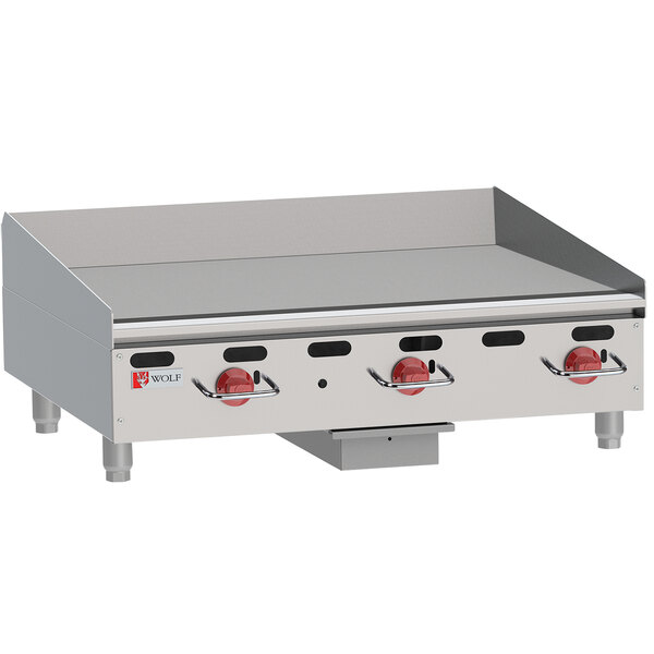 A Wolf natural gas countertop griddle with manual controls.