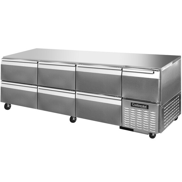 A stainless steel Continental Refrigerator with six drawers and one half door under a counter.