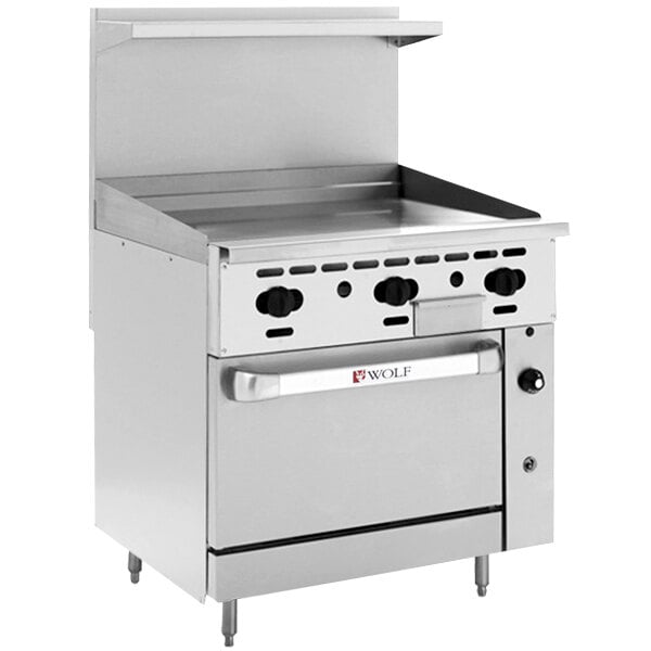 A large stainless steel Wolf commercial range with griddle and standard oven.
