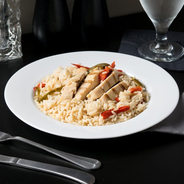 A 10 Strawberry Street Classic White porcelain lunch plate with rice and chicken on it.