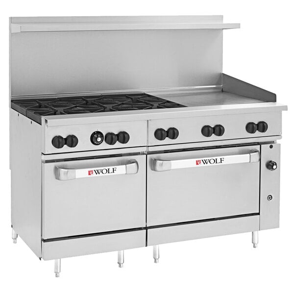 A large stainless steel Wolf commercial range with a griddle, 4 burners, and black knobs.