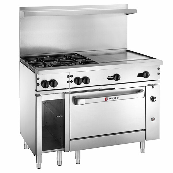 A large stainless steel Wolf thermostatic range with 4 burners, a griddle, and an open oven door.