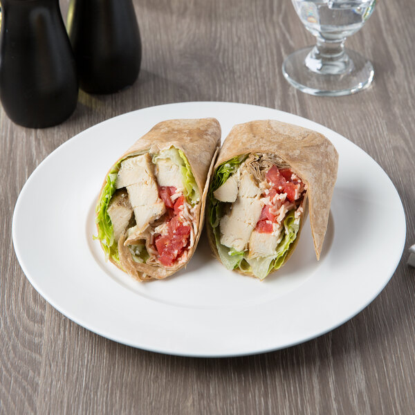 A Chicken wrap on a 10 Strawberry Street white porcelain luncheon plate on a table.