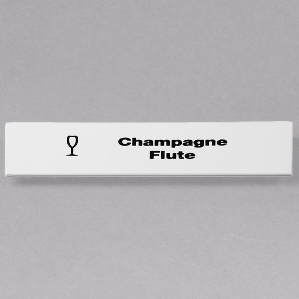 A white rectangular sign with black text that says "Champagne Flute"