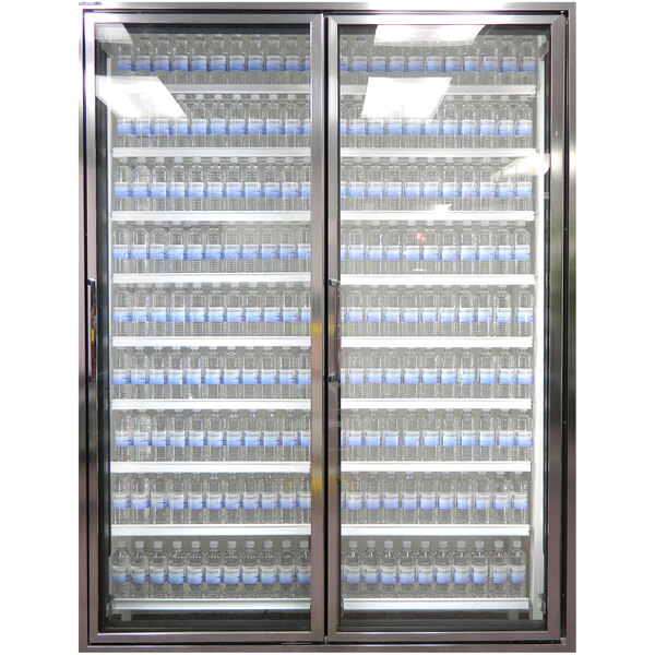 A Styleline Classic Plus walk-in cooler door with a glass window and shelving holding bottles of water.