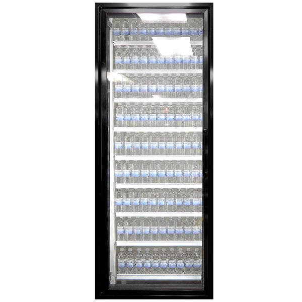 A black Styleline walk-in cooler door with glass panels and shelves holding water bottles.