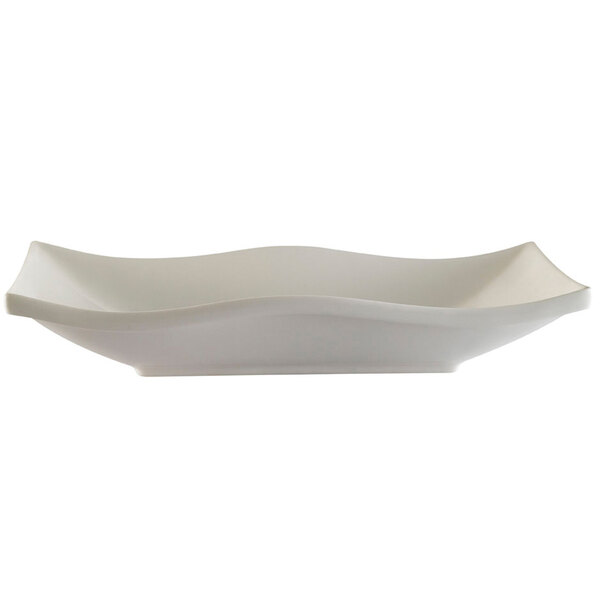 A CAC white porcelain rectangular platter with a wavy edge.