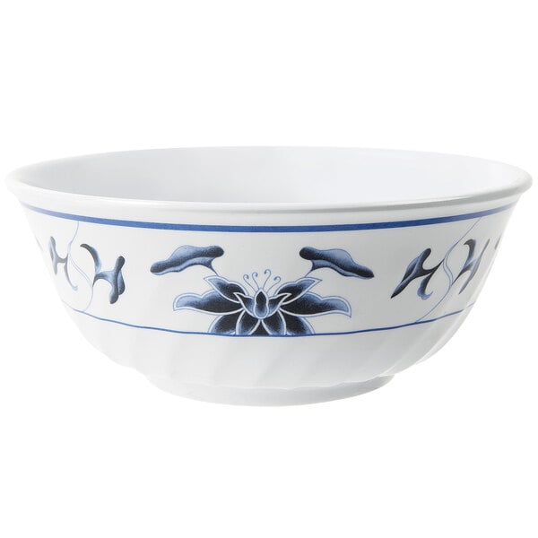 A white fluted melamine bowl with blue and white water lily design.