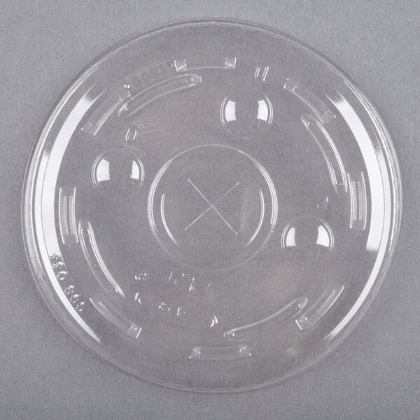 A clear plastic Dart container lid with a straw slot.