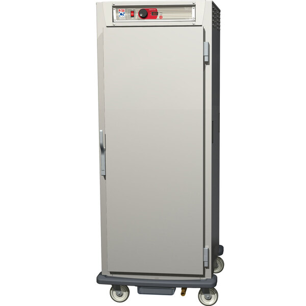 A silver Metro C5 heated holding cabinet with wheels and white doors.